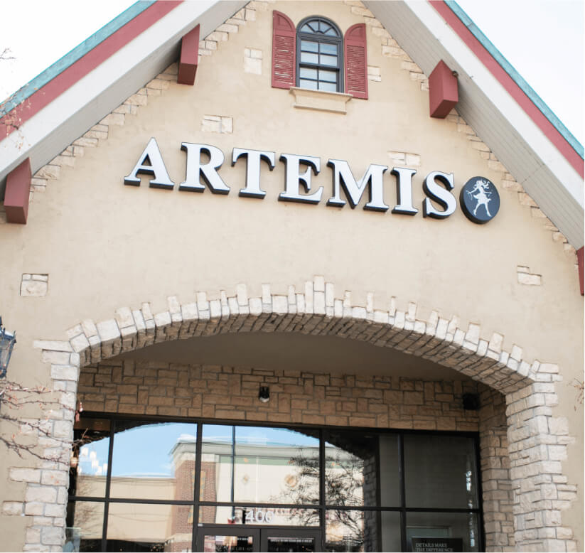 large cream building with artemis logo on the front 
